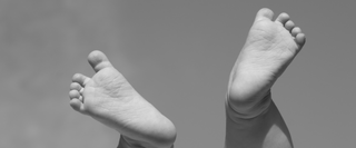  Black and white photo with babies feet in the air highlighting Blissed Botanical Co classic bar soaps collection